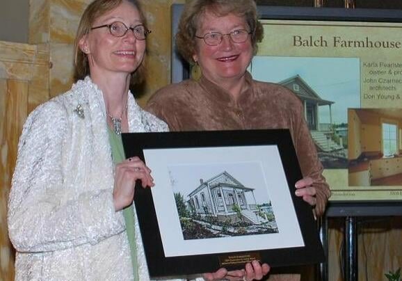 Karla (on left) receives award from Joanne Carlson, President, Bosco-Milligan Foundation