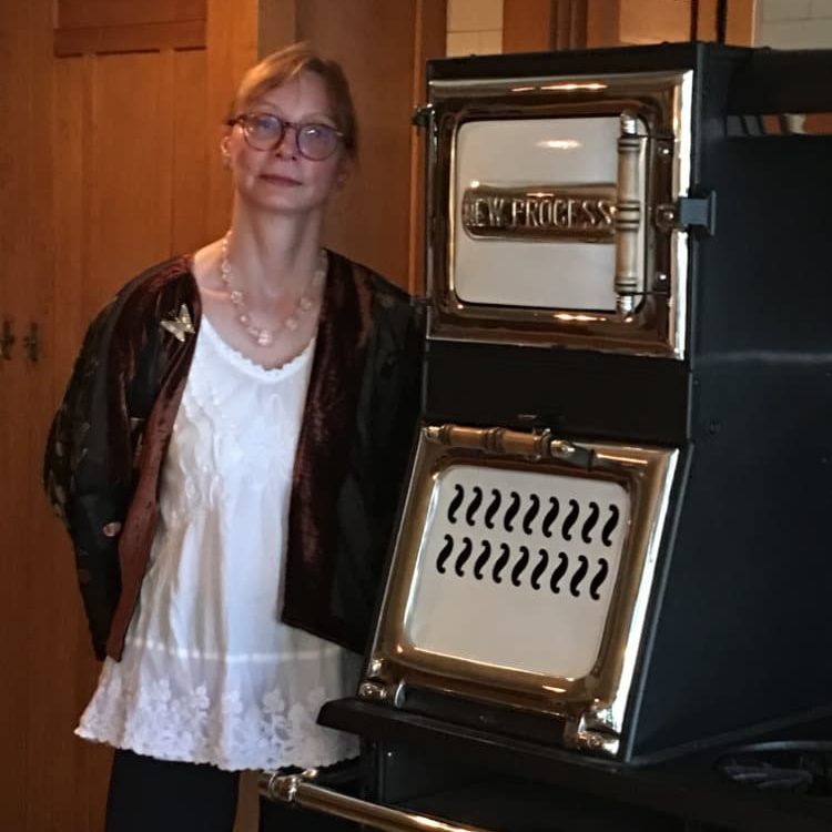 Karla Pearlstein standing next to Gamble House oven